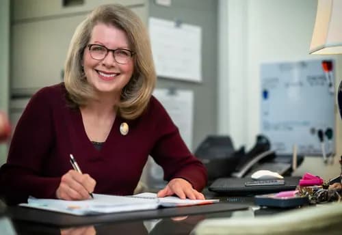 Professional smiling while working at an office desk