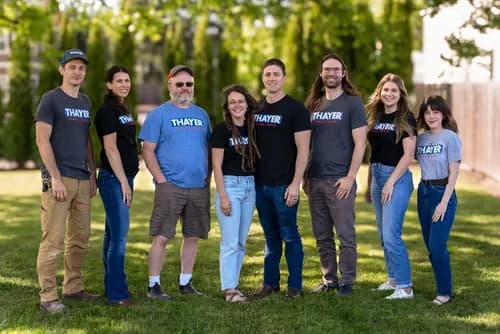 Workplace team photographed outdoors for a relaxed company group portrait