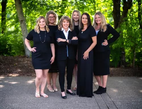 Real estate team photographed together outdoors for a coordinated company portrait