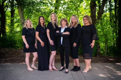 Real estate team gathered outdoors for a cohesive group portrait
