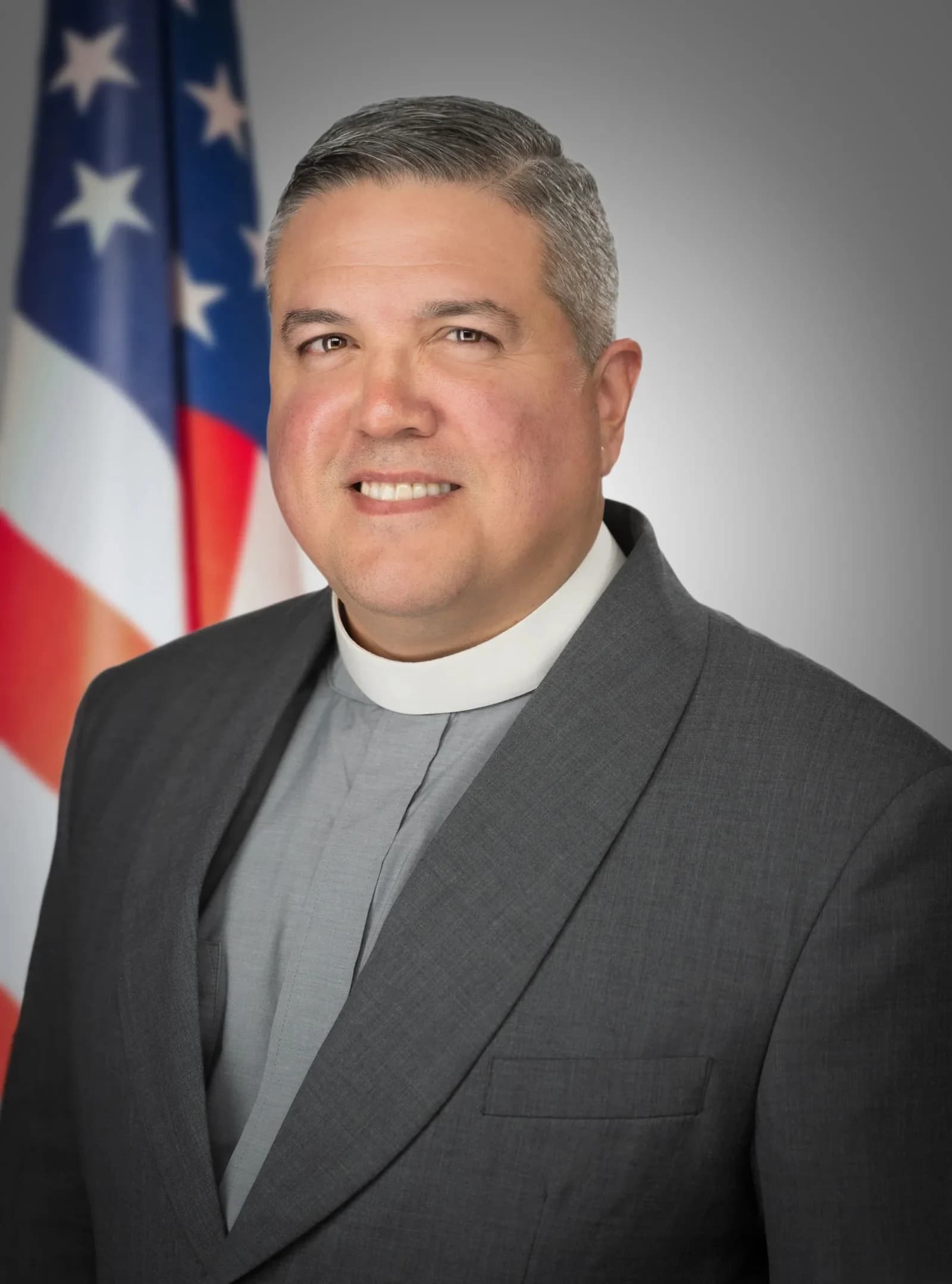 Formal clergy studio portrait for community and church communications