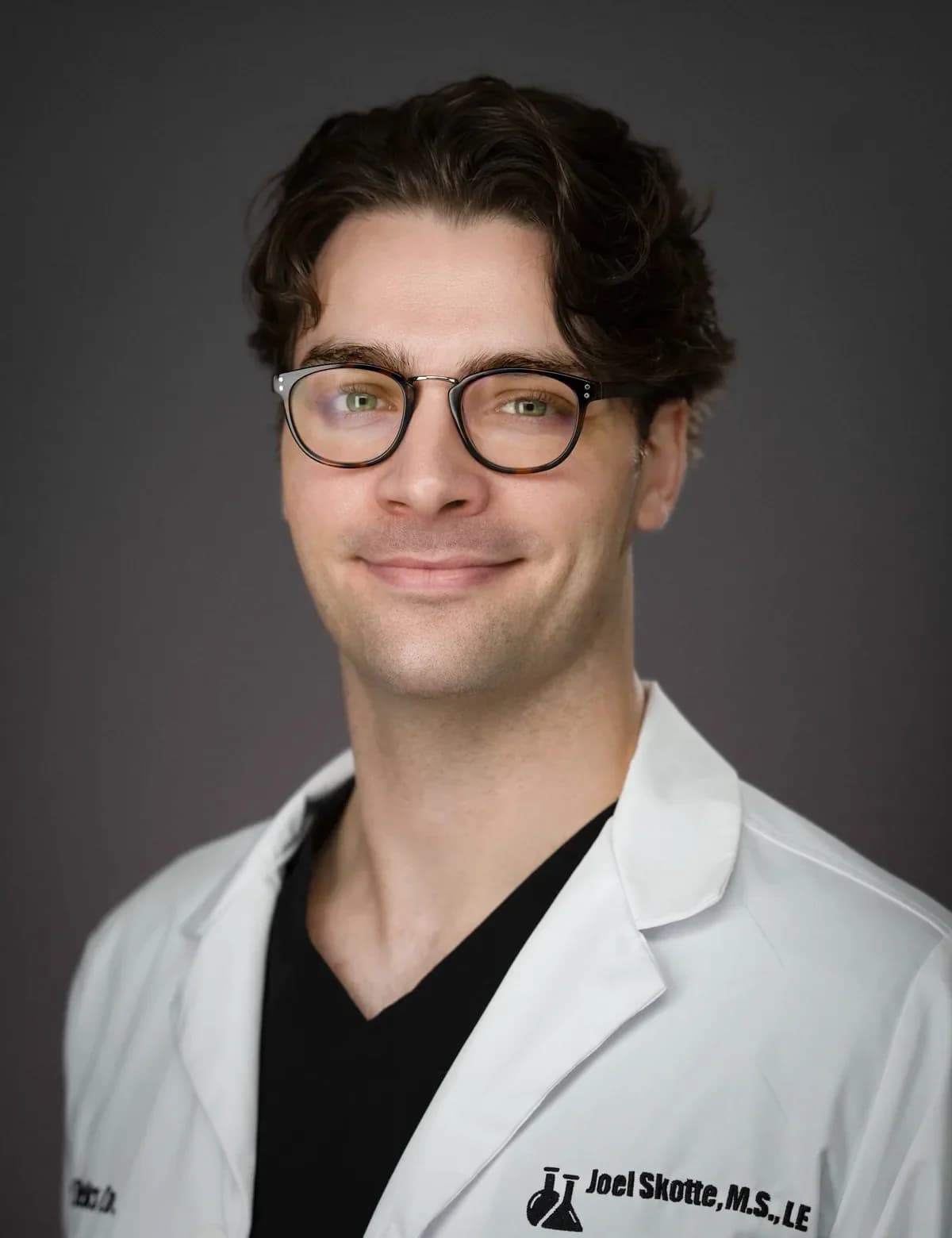 Composed professional studio portrait for an event producer